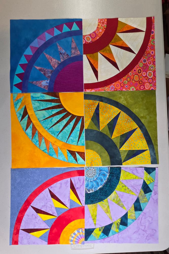 Six quilt blocks for a colorful New York Beauty quilt.