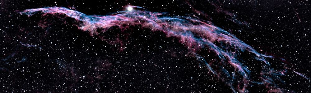 The Western Veil Nebula is a gauzy pink and blue nebula that looks like a scarf or veil blowing in the wind, but in space. Image taken by Joanna Woo at the Trottier Observatory