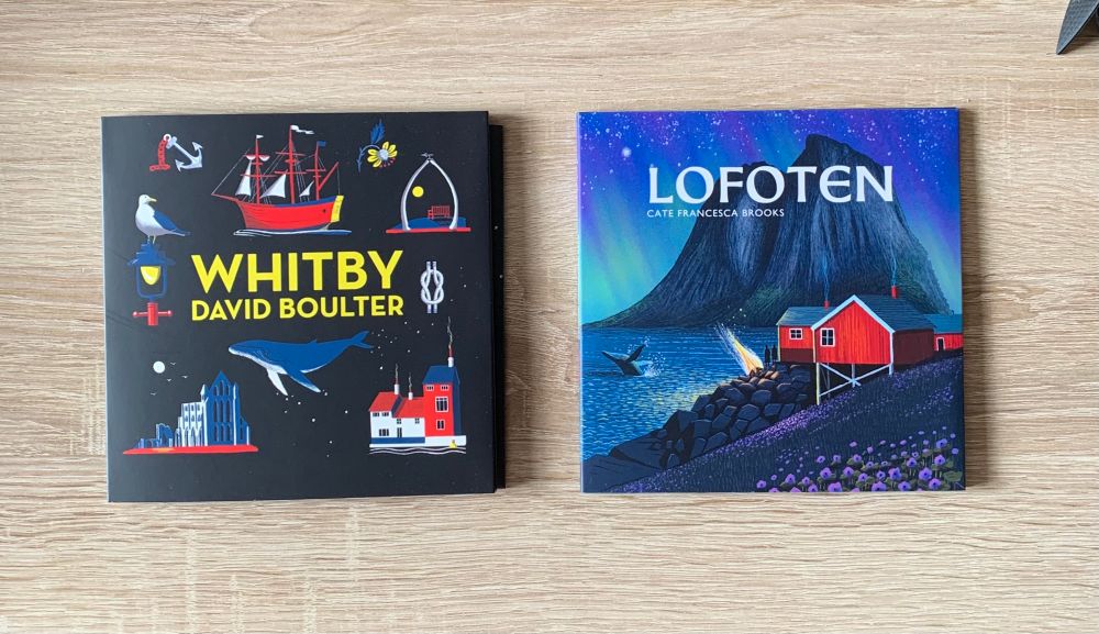 CD covers for the album Whitby by David Boulter including maritime images and for the album Lofoten by Cate Francesca Brooks which is an image of a Nordic coast and buildings on the shore. 