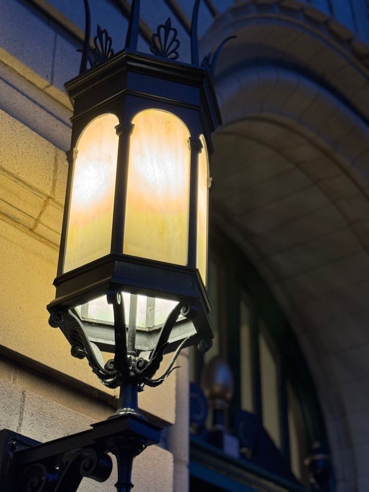 Old iron light fixture on historic building.