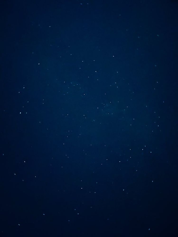 distant stars twinkling in the deep blue void