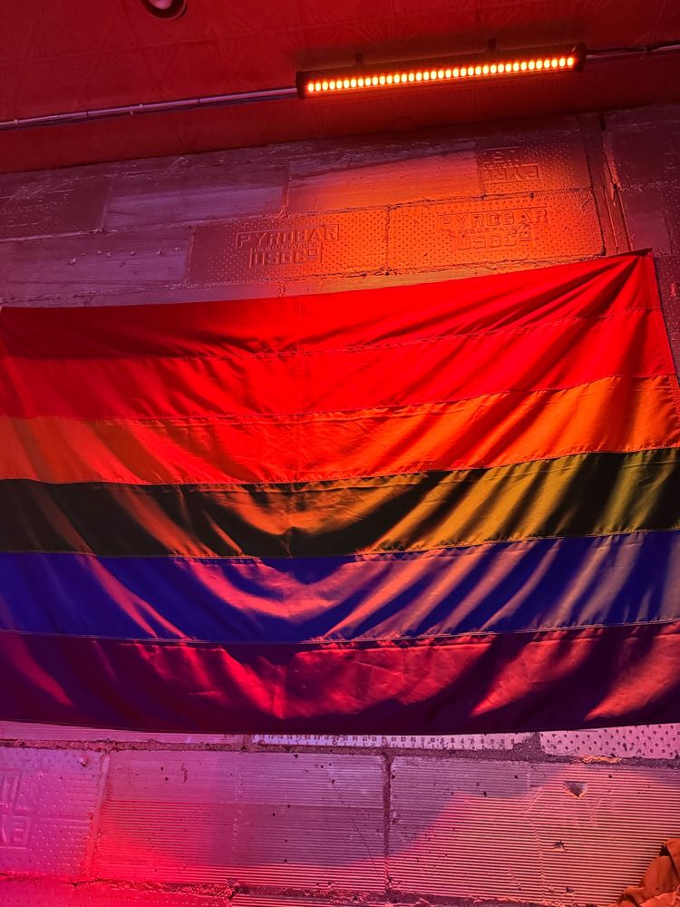 Rainbow flag on stone wall
