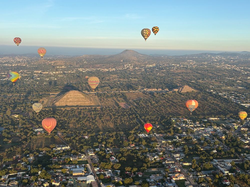 Hot air balloons over the pyramids of Teotihuacan as seen from above 