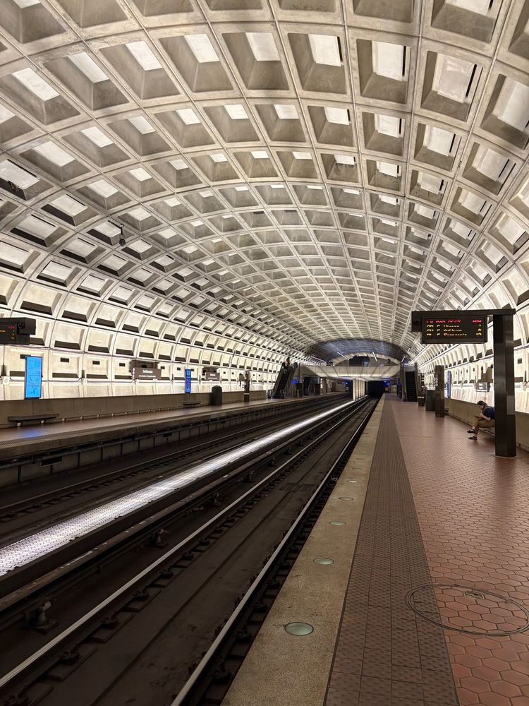 A DC Metro station with its nondescript brutalist white ceiling pattern