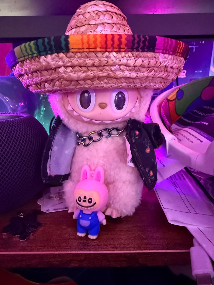 A labubu in a sombrero with a baby labubu