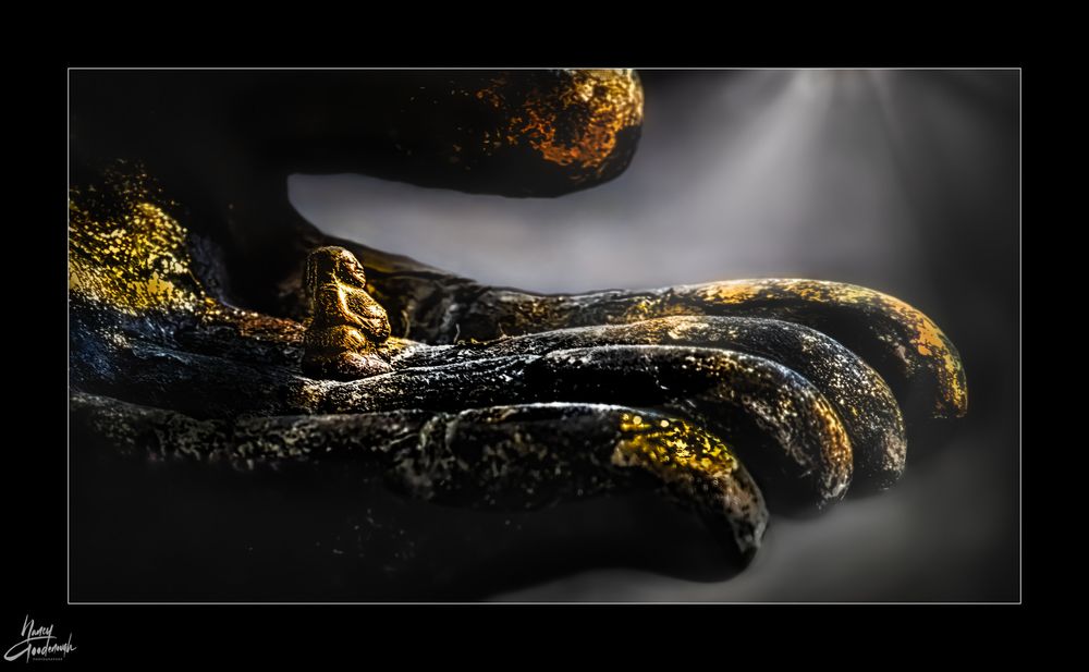 I found this scene in a wat (temple) near where we were staying for month in Bangkok. I call it "Light of the Buddha on the Buddha" A small amulet of the Buddha is sitting in the large hand of the big Buddha statue, with gold leaf both over the amulet and the large hand of the towering Buddha. I chose this image for the #AlphabetChallenge with it being a #WeekLforLyrics While looking for lyrics to go with my image of the Buddha in the #Hand of the Buddha, I found this wonderful peaceful recording called Chant of Metta (Loving Kindness) https://www.youtube.com/watch?v=HZgsAstw9C0