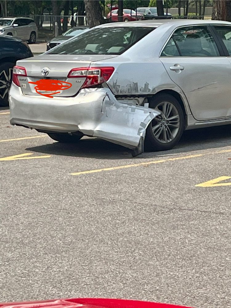 Car with a bumper that was taped on but how now fallen off 
