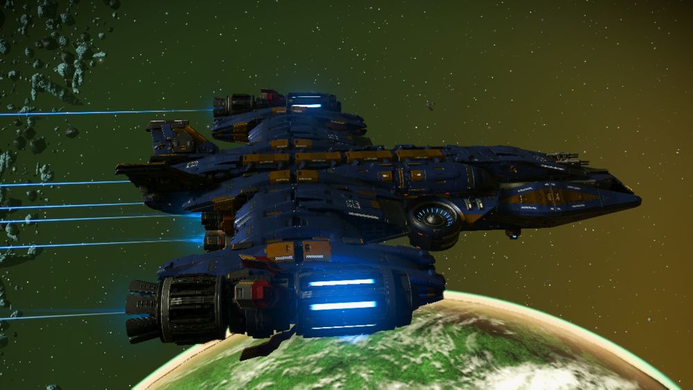An image of a No man's Sky corvette, flying through space. below is the arc of a planet, mostly green, and the starry background also has a green tinge. The ship itself is blue and gold, with two large outrigger engines on its wings. two small tailfins are above the wing. The front of the ship is pointed, looking rather raptorlike, and for those who are aware, it looks a tiny bit like the Phoenix from 'Battle of the Planets', the American version of Science Ninja Team Gatchaman. (see the other images)