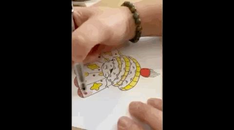 A GIF of me drawing an illustration of a cute, curled up snake for 2025 Lunar New Year as I make hand make cards for family and friends. 