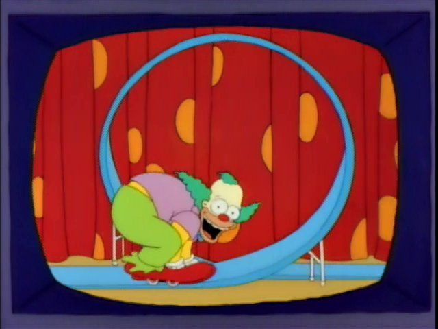 Krusty the Klown on his tiny-ass bicycle as he's about to go through a loop