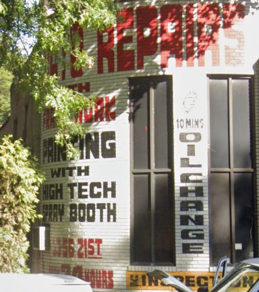 Hand-painted signage directly on a brick wall, advertising Auto Repair, Painting with High Tech Spray Booth. The letters are very vertical but rounded, with heavy with very small spaces (voids? there's a font design term for this) in the P's and R's and A's and O's. Also the K has a cool curved shape.