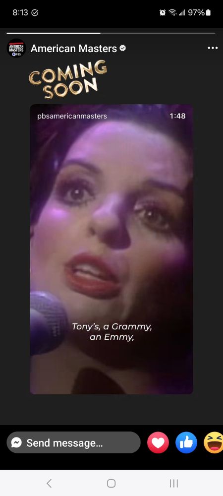 A photo of Liza Minelli's face with a microphone in front of her. 