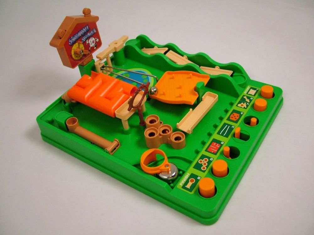 Image of the toy "Screwball scramble" in which a marble is being navigated through a plastic obstacle course with elements controlled by the player using versions knobs and buttons