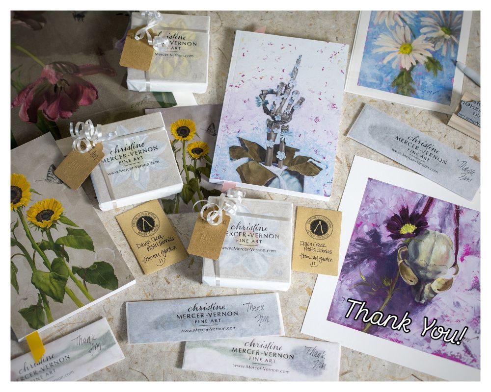 Flat lay photo of mini paintings, prints, notebooks, and bookmarks all wrapped and ready to ship out to fulfill holiday orders. 