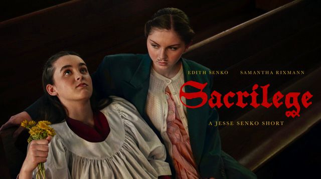 Two teenage girls sit alone in an empty church. One wears a choir robe, the other has a drawn on moustache and is wearing a suit jacket that is much too large over her dress. 