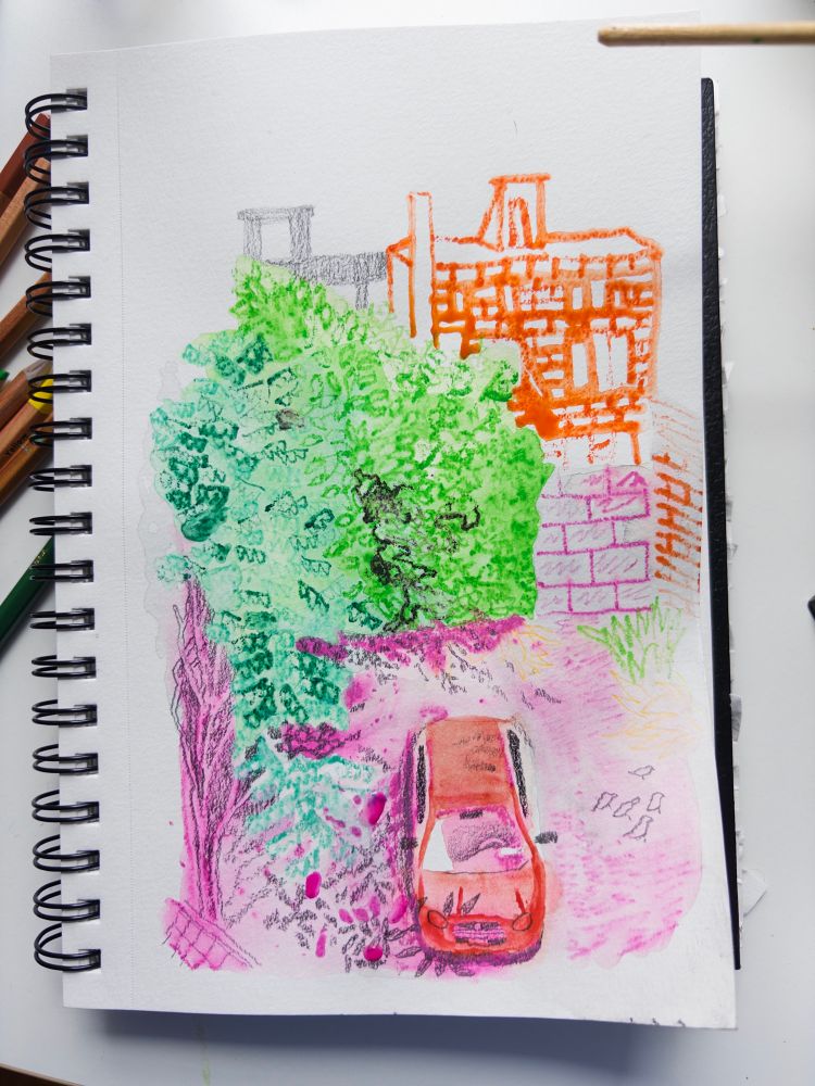 It’s a notebook that you drew a colorful watercolor pencil + graphite sketch of an empty city lot surrounded by buildings with a red car in it and some birds 