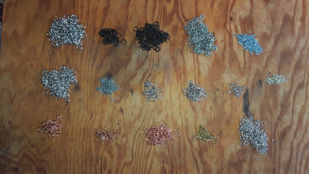 Assorted metal rings on a wooden workbench.