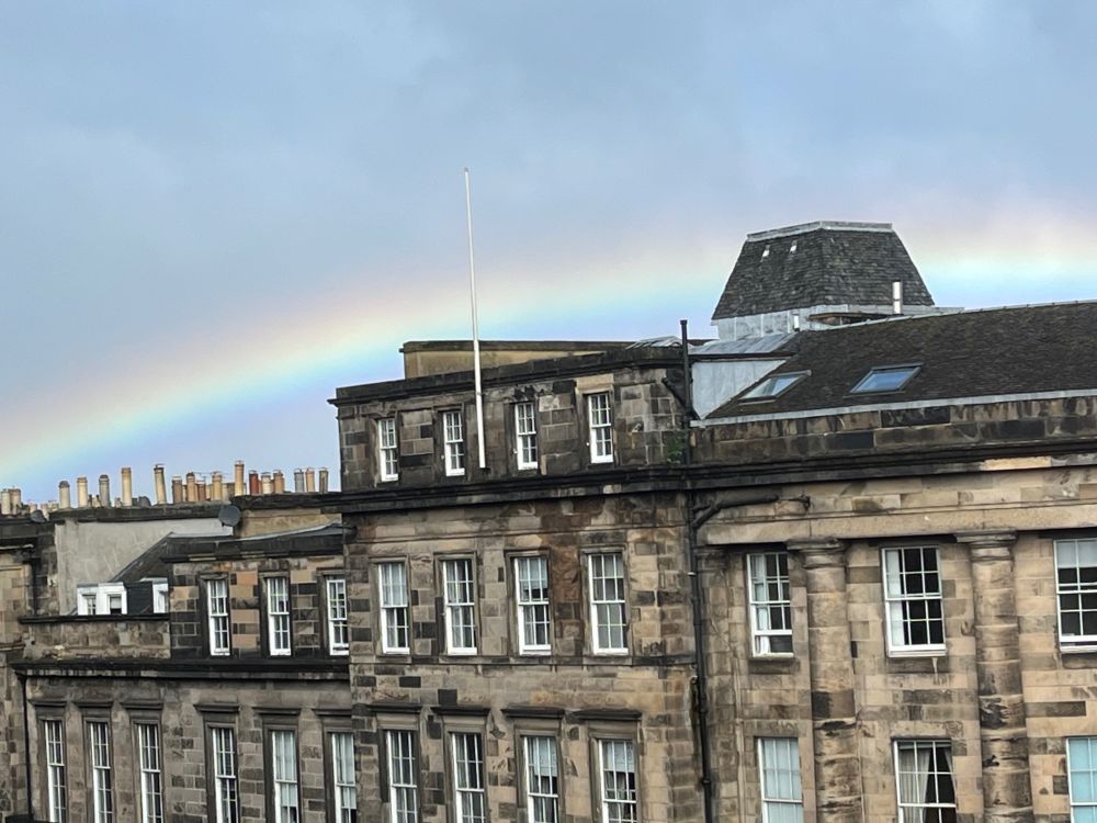 Georgian buildings with a rainbow arcing over the roofs.