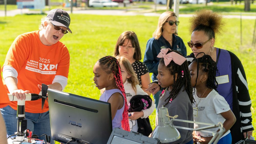 A person teaching a group of kids.