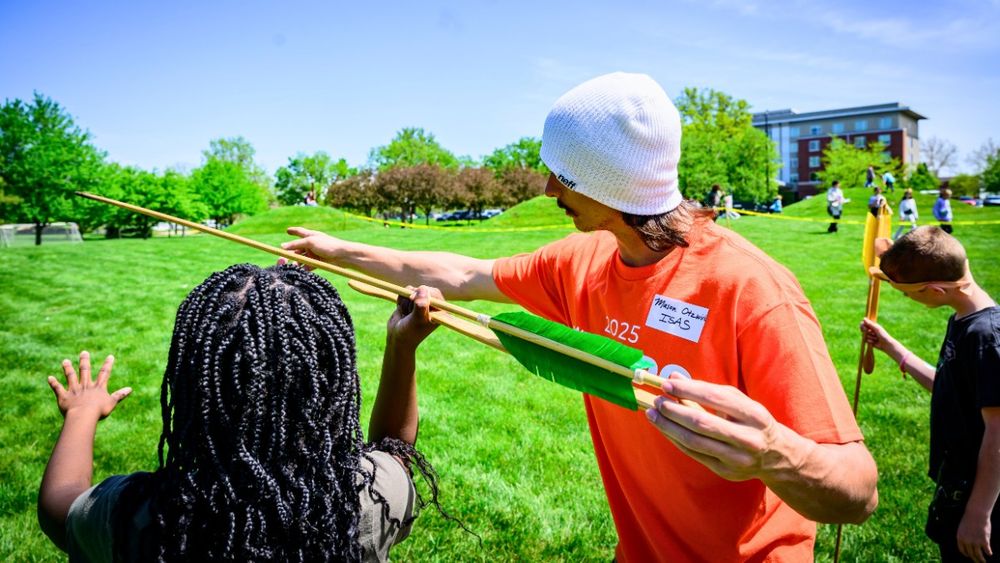 A person demonstrating how to throw an atlatl