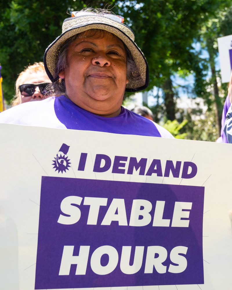 a worker with an I demand stable hours sign