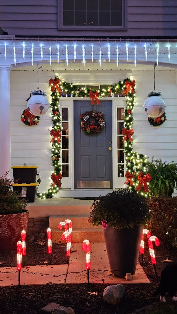 Front door framed by XMAS lights & decorations.