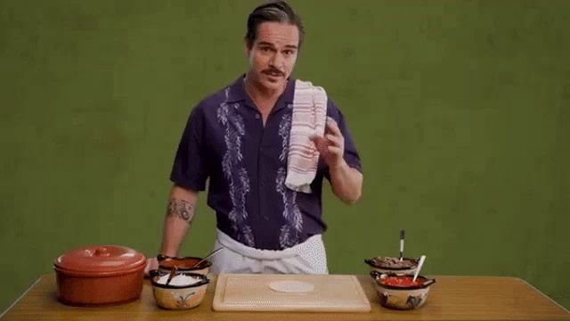 a person is cutting a piece of meat on a cutting board .