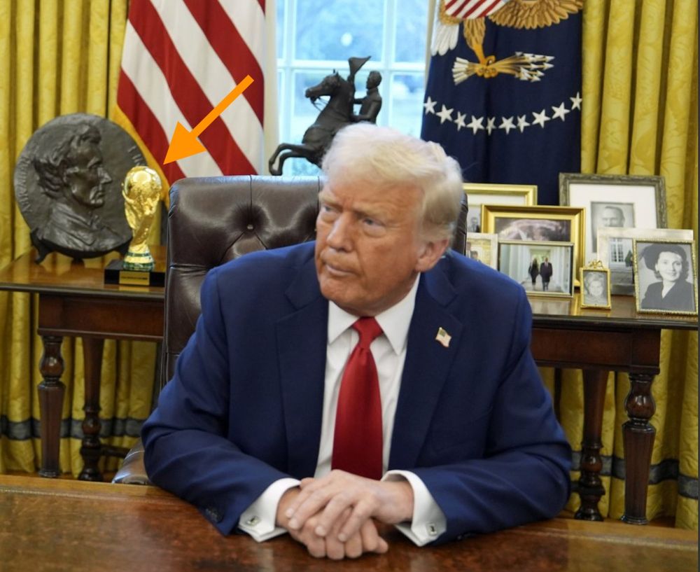 Donald Trump in the Oval Office with the World Cup Trophy in the background