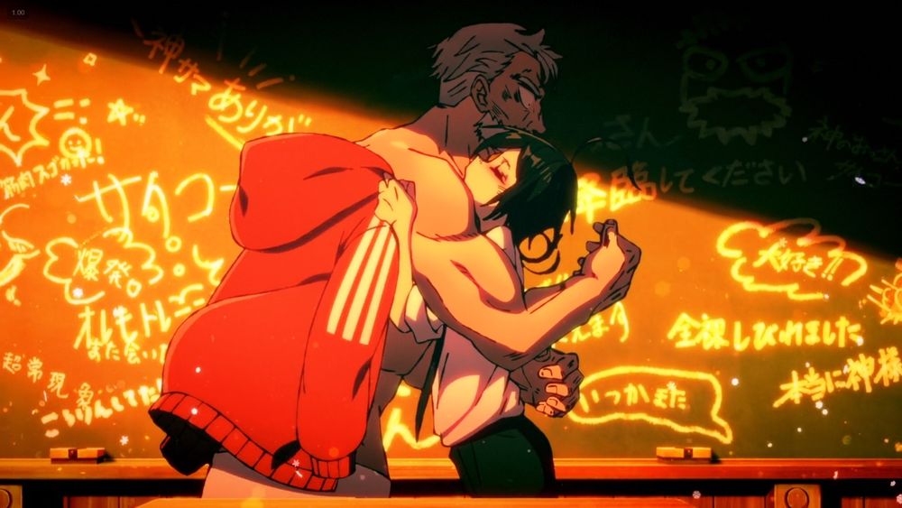 Fuyumura hugging Sanda as a buff old man with her arms holding up a red jacket behind him.