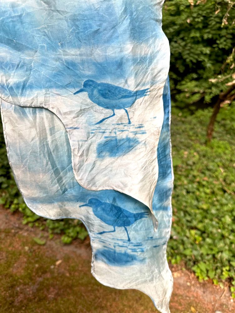 A closeup of more sandpipers printed on the reverse of the scarf