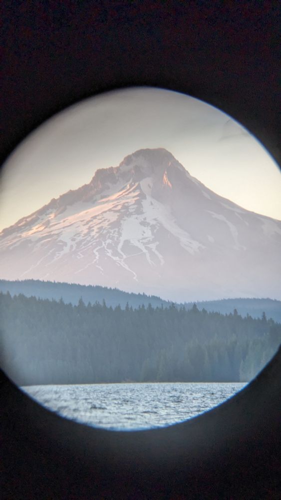 Photograph of Mt. Hood in the evening taken through a binocular lens. 