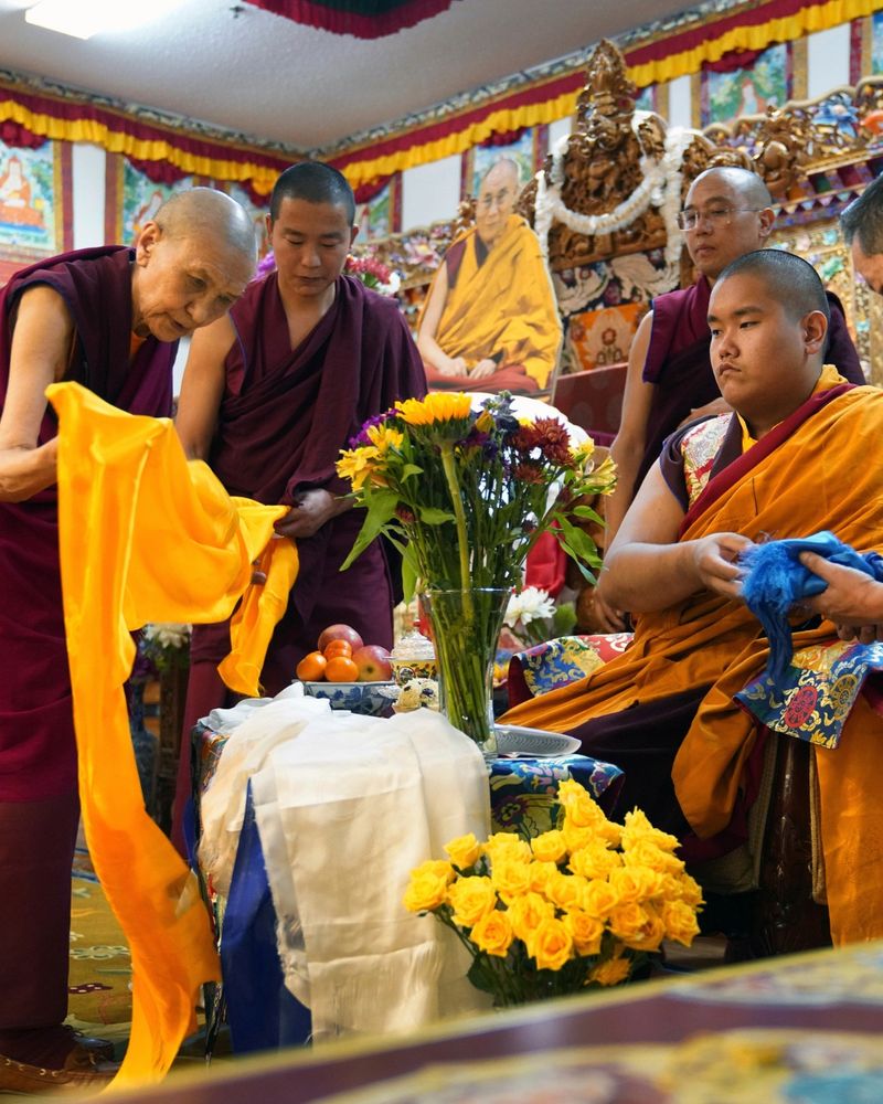 Monks bow and present “khata” to teenage Buddhist lama, Jalue Dorje, at his 18th birthday and enthronement ceremony in Isanti, Minn., on Saturday, Nov. 9, 2024.