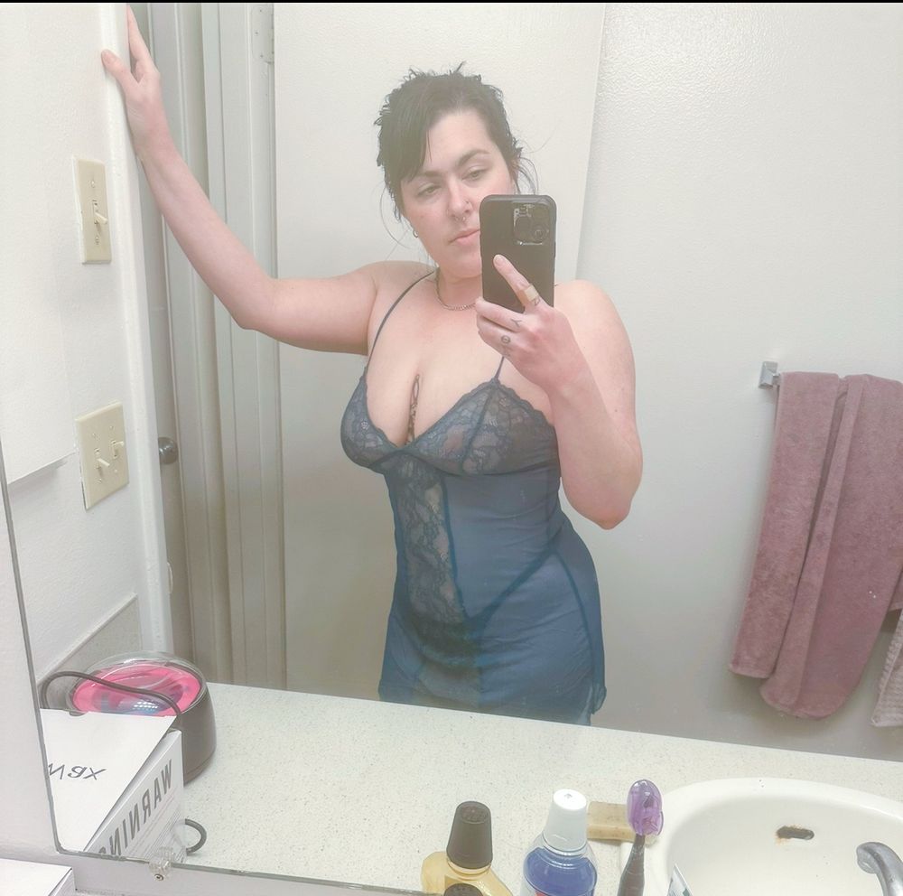 Stormy nightingale is leaning against her bathroom doorframe in a turquoise lingerie slip 