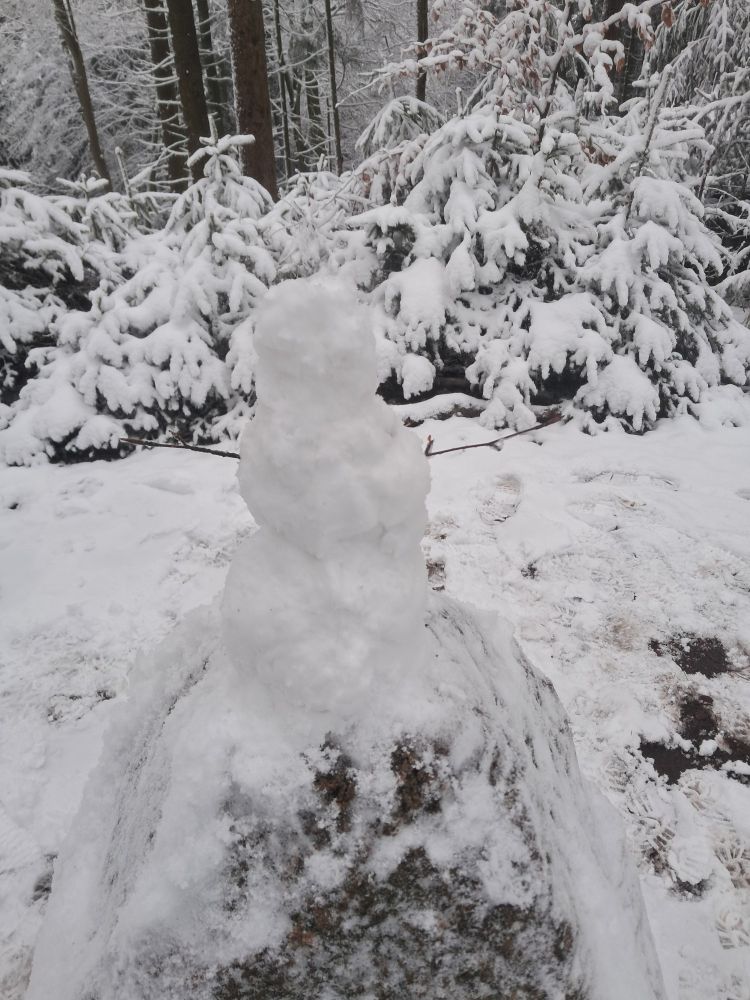 View broadly above the same rock, with small snowman built on top