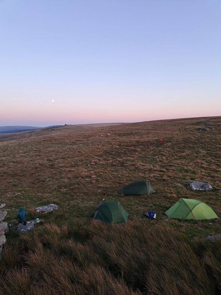 Dartmoor sunset looking SSE. Near full moon small but bright. Three green tents in foreground