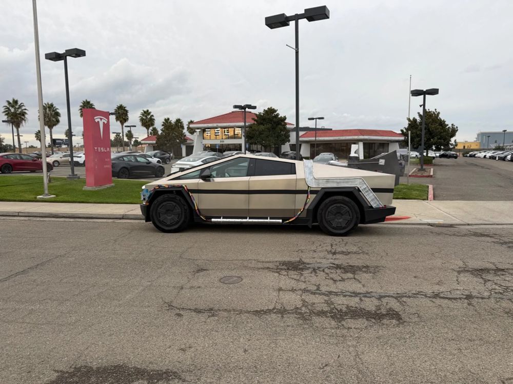 photo of a cybertruck modified to look like the Delorean from "Back to the Future"