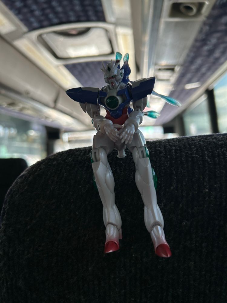 Robot Spirits Side MS ELS Qan[T] sitting on a bus seat head rest