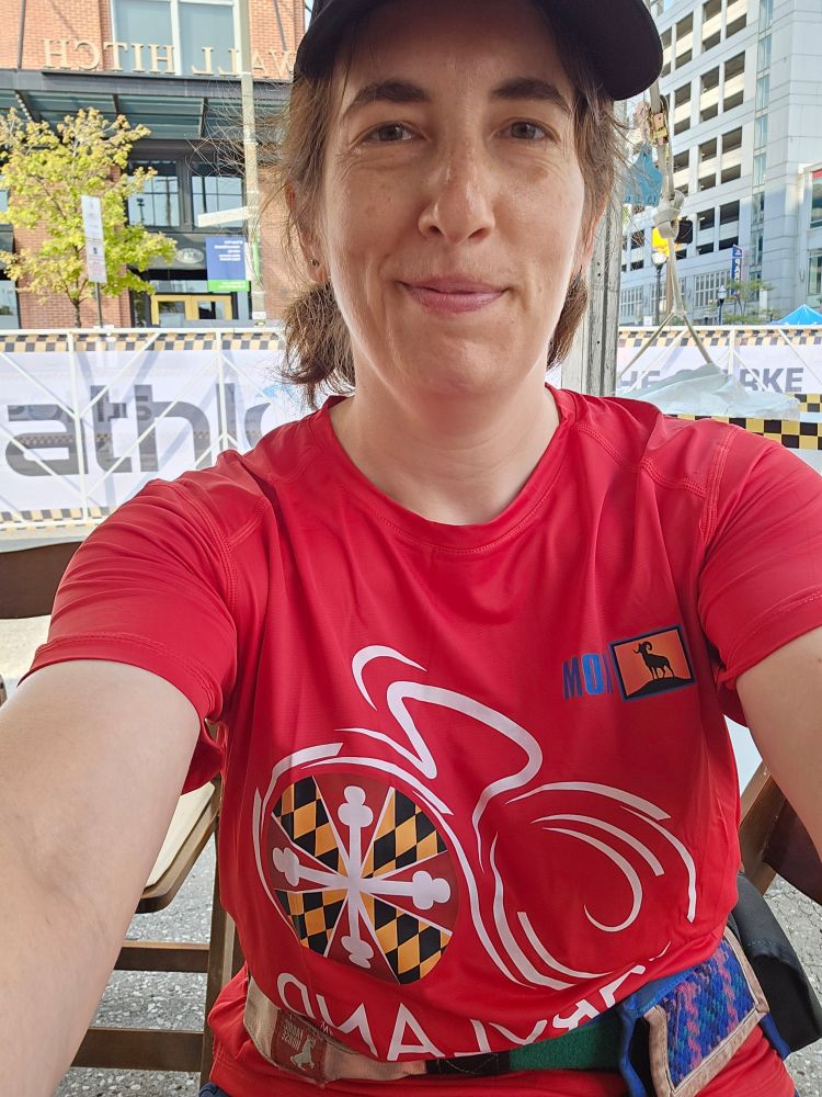 Meee in the Maryland Cycling Classic volunteer shirt, in the VIP finish line area
