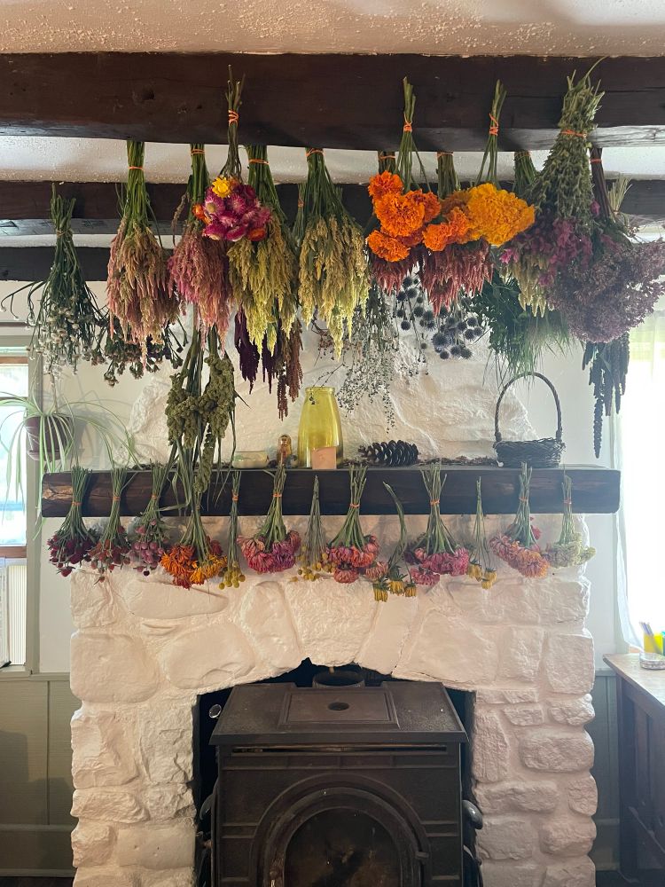 Flower bunches hanging above a stone fireplace