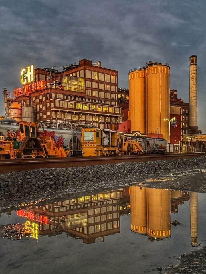 Sunlit C&H sugar factory reflected in the water, in Crockett, California