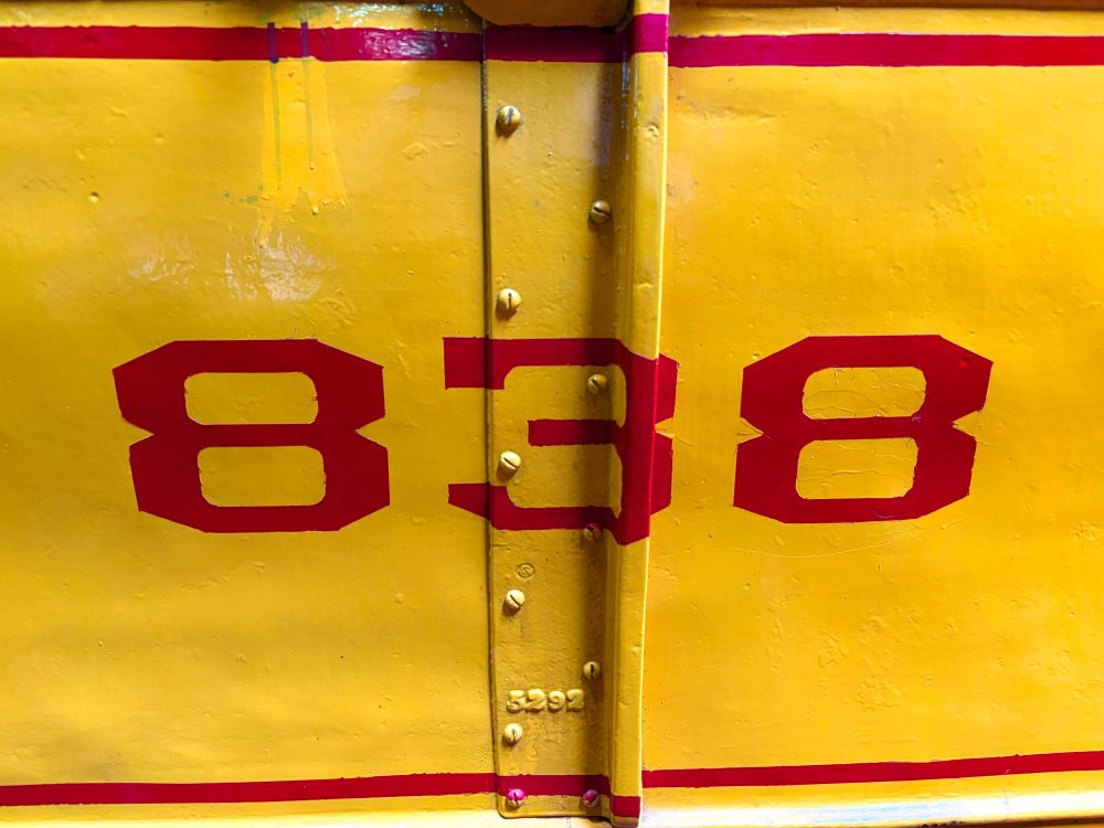 Painted red numbers on yellow.