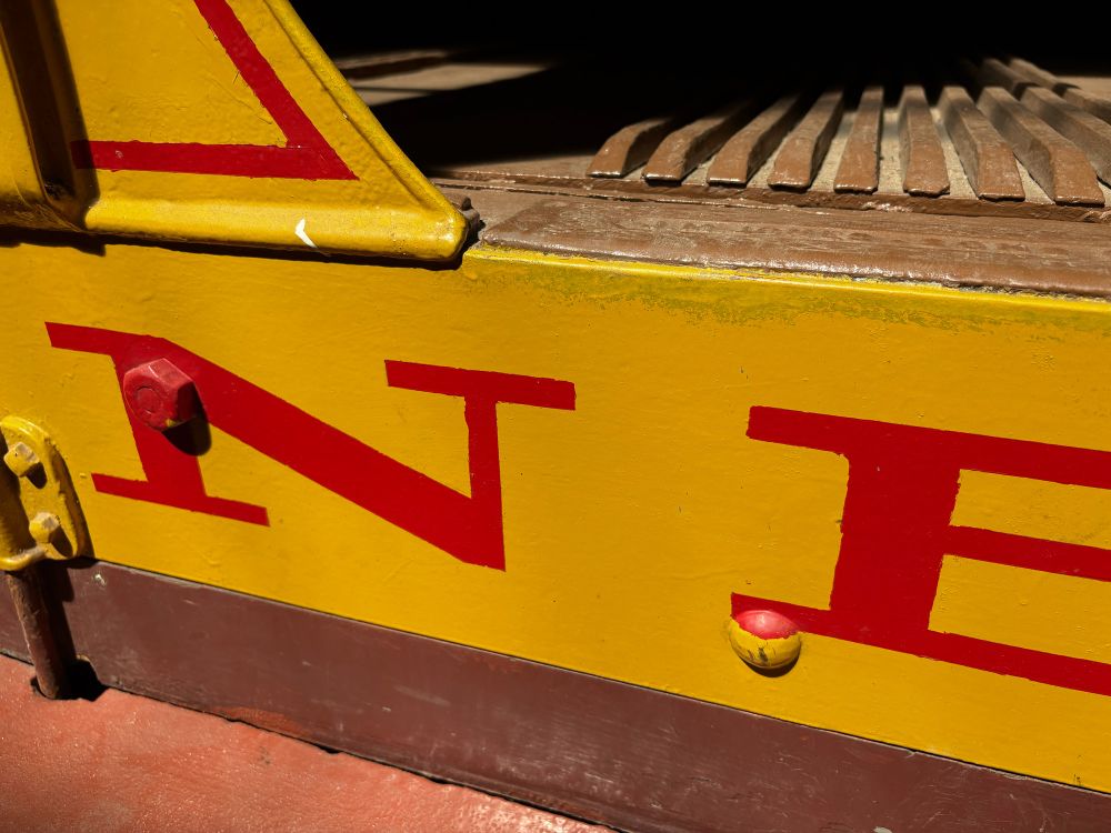 Painted red letters on yellow.