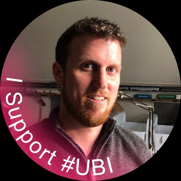 My handsome mug with a colorful red gradient bur effect coming up from the "bottom" rotated 45deg encapsulating the text "I Support #UBI"