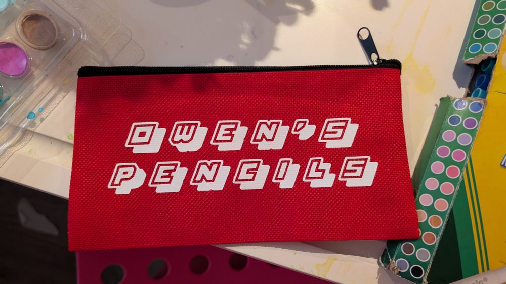 A red pencil with the writing "Owen's Pencils"