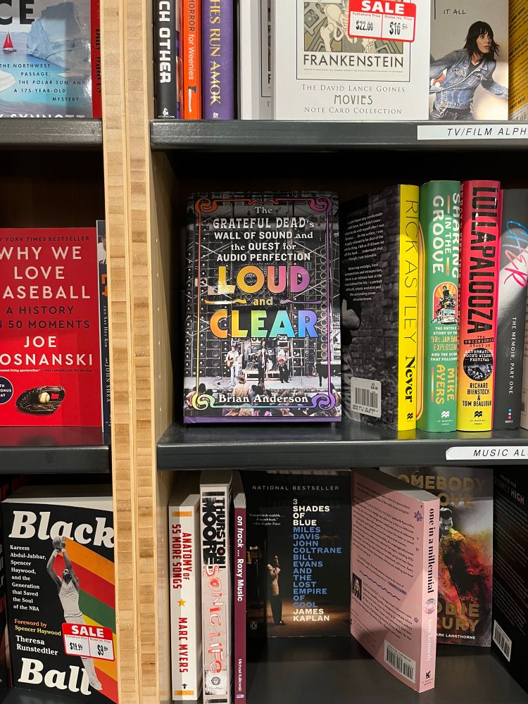 Signed copy of LOUD AND CLEAR on the shelf at Compass Books in SFO