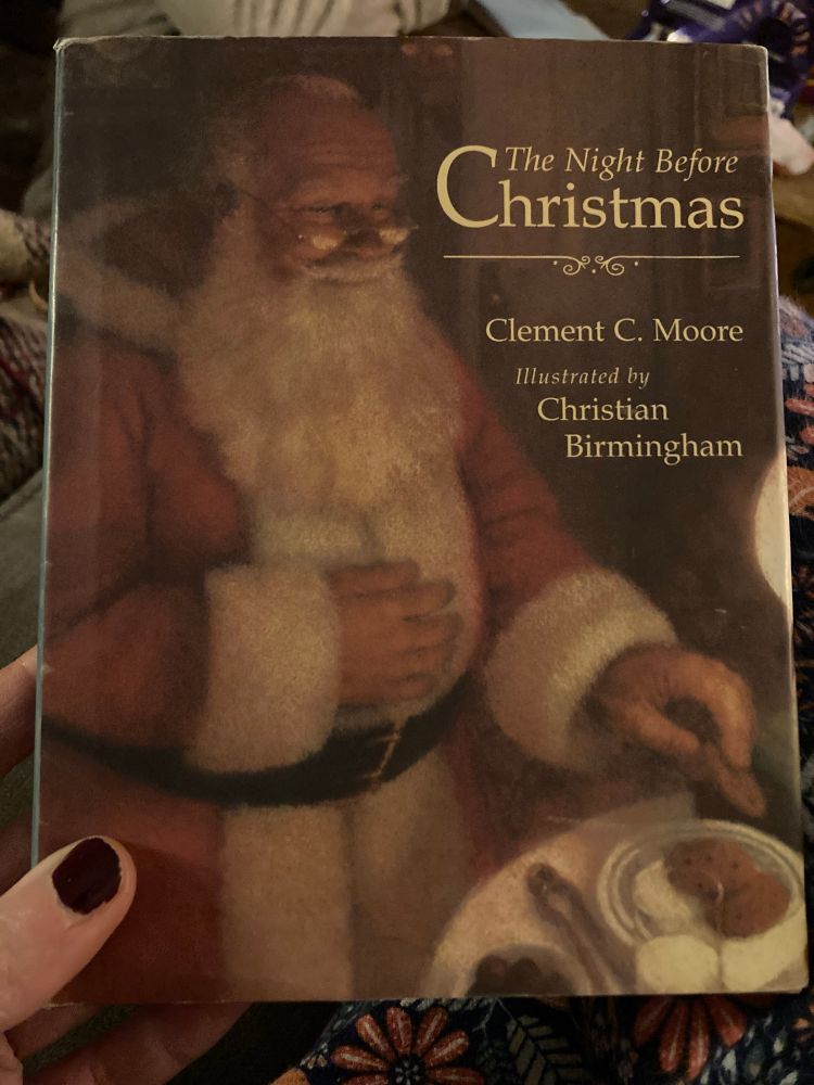 Cover of ‘The Night Before Christmas’, showing Father Christmas taking a cookie from a plate 