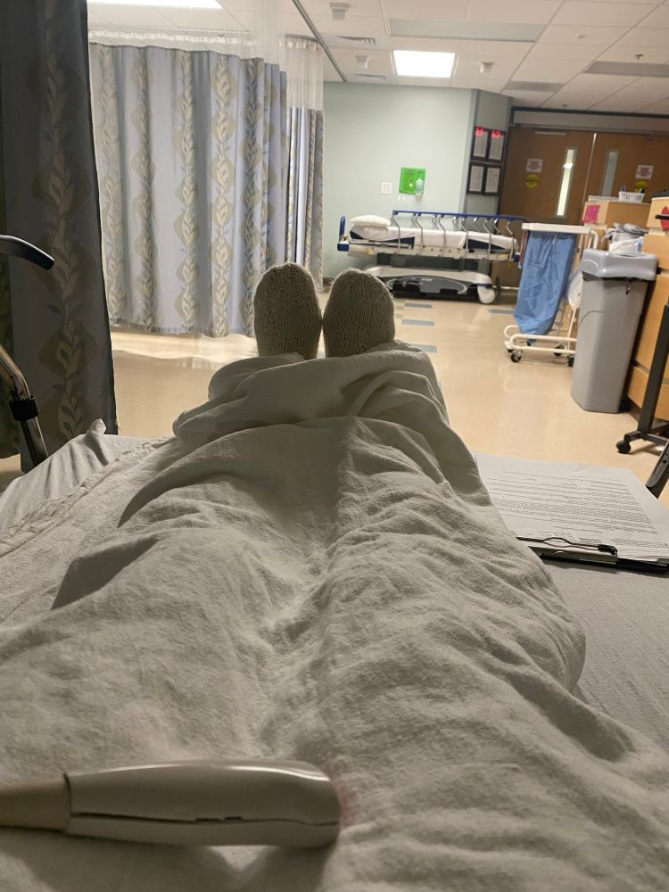 Pair of feet on a bed waiting in a surgicenter for a procedure 