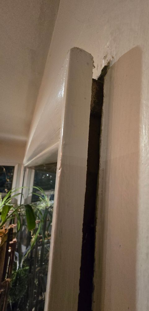 An interior window frame popping inward, away from the wall.