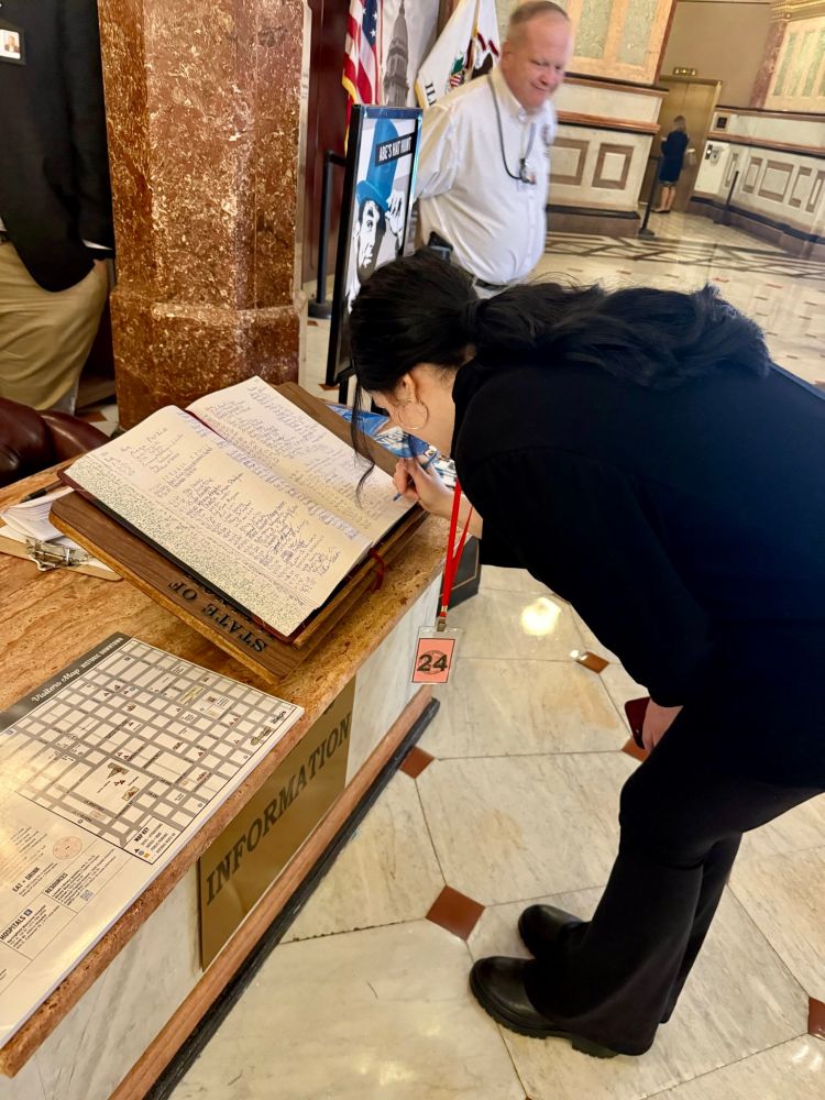 Leticia signs the Springfield guestbook.