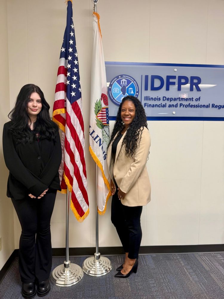 Denysha and Leticia smile for a photo outside the IDPFR office. 
